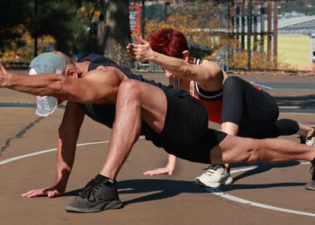 Athlete demonstrating the difference between mobility and flexibility through dynamic and static stretching.