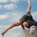 Athlete performing Flying Split arm balance (Eka Pada Koundinyasana II) demonstrating core strength, balance, and full-body control