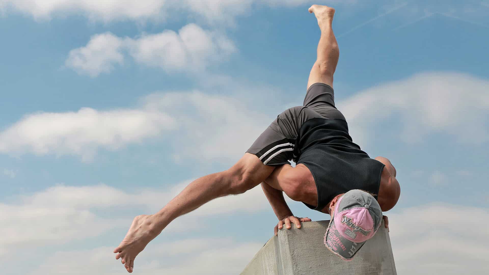 Athlete performing Flying Split arm balance (Eka Pada Koundinyasana II) demonstrating core strength, balance, and full-body control