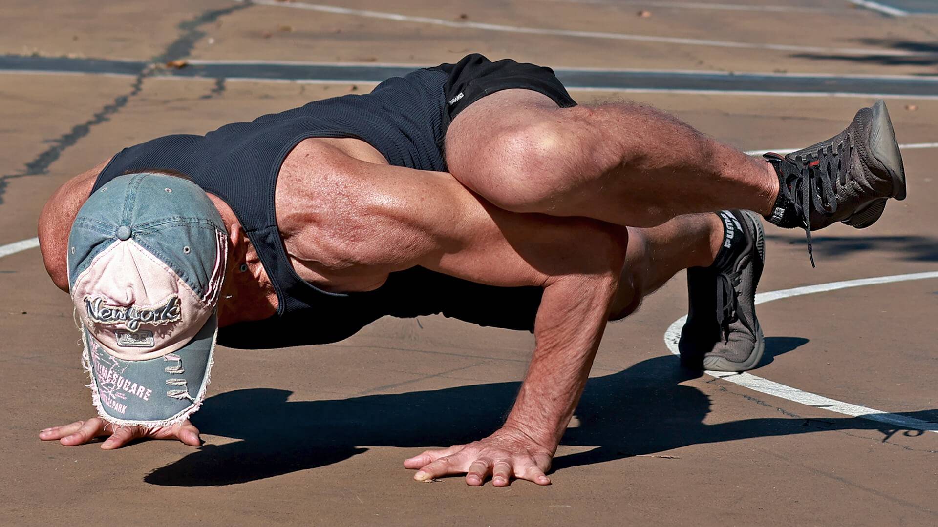 Athlete performing a push-up variation with knee on upper arm to activate the psoas muscle and core connection.